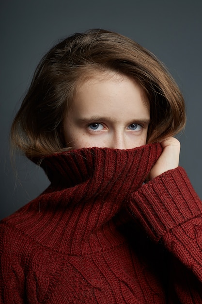 Beauty portrait of a beautiful young girl on a dark wall.
cosmetics for teenagers, acne treatment