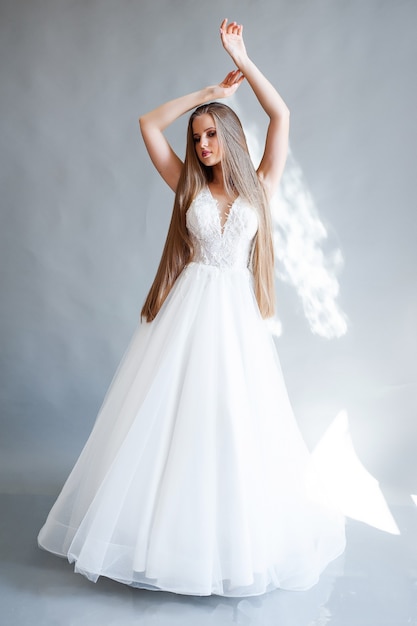 Beauty portrait of blonde bride wearing fashion wedding dress