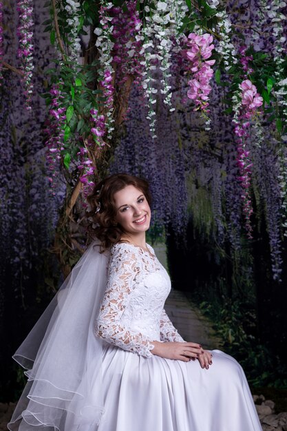 Beauty Portrait of bride wearing in wedding dress with voluminous skirt, studio photo