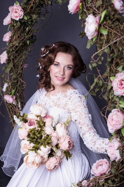 Beauty Portrait of bride wearing in wedding dress with voluminous skirt, studio photo