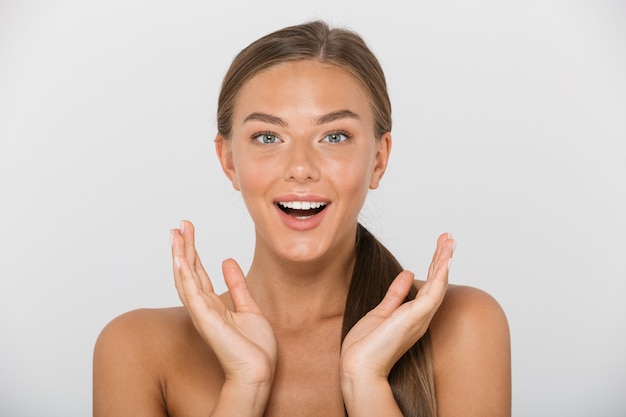 Beauty portrait of caucasian shirtless woman with long brown hair smiling, isolated