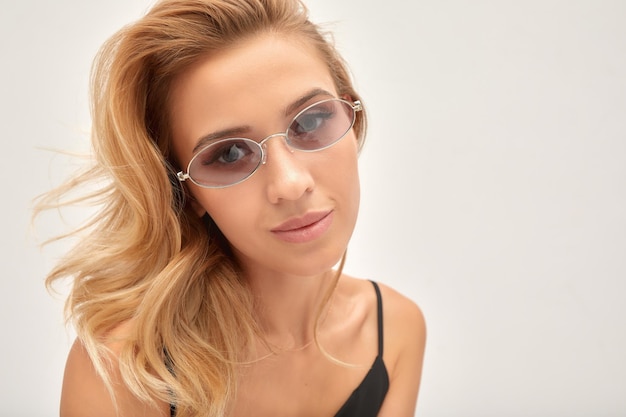 Beauty portrait of elegant attractive blonde woman wearing stylish sunglasses Fashionable hairstyle