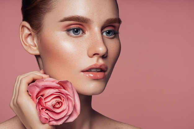 Beauty portrait of a girl with red rose