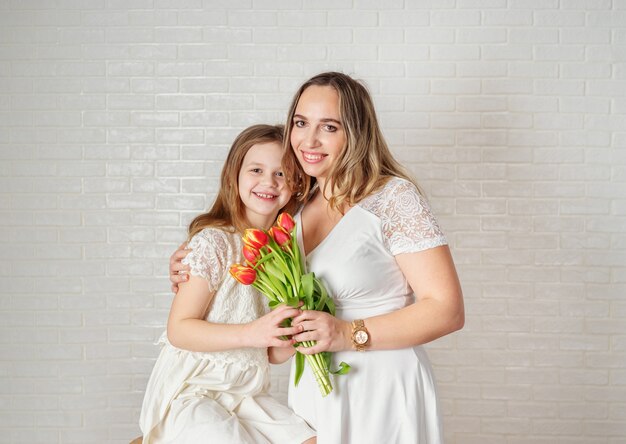 Beauty portrait of mother and daughter on white