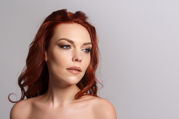 Beauty portrait of a redhaired beautiful woman Place for copyspace