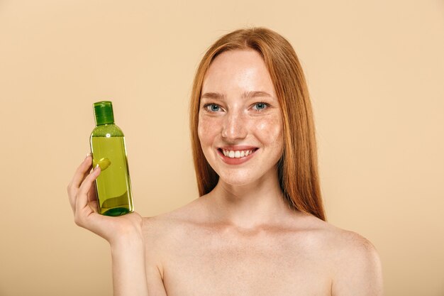 Beauty portrait of a smiling young topless redhead girl