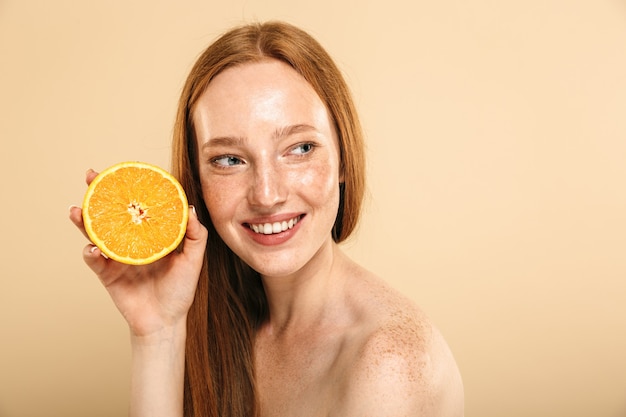 Beauty portrait of a smiling young topless redhead girl