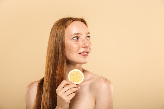 Beauty portrait of a smiling young topless redhead girl