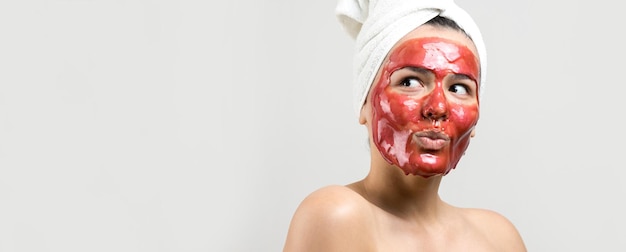 Beauty portrait of woman in white towel on head with gold nourishing mask on face Skincare cleansing eco organic cosmetic spa relax concept