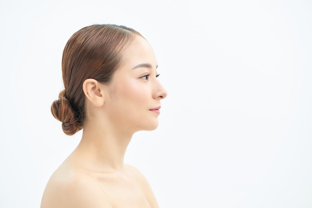 Beauty portrait of a young attractive half naked woman with perfect skin looking away isolated over white background