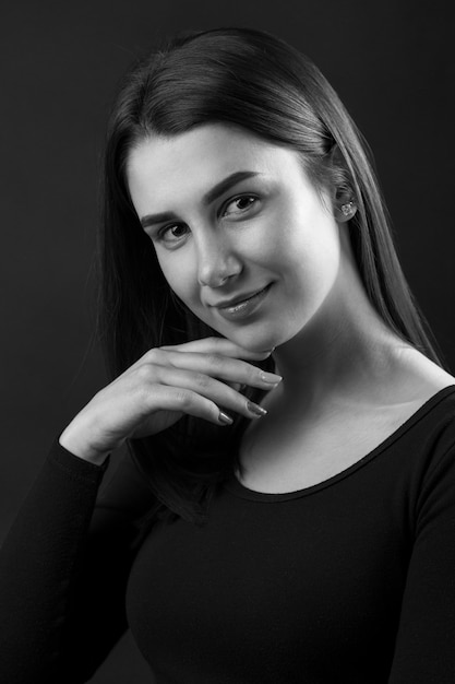 Beauty portrait of a young beautiful brunette girl. Black and white photo.