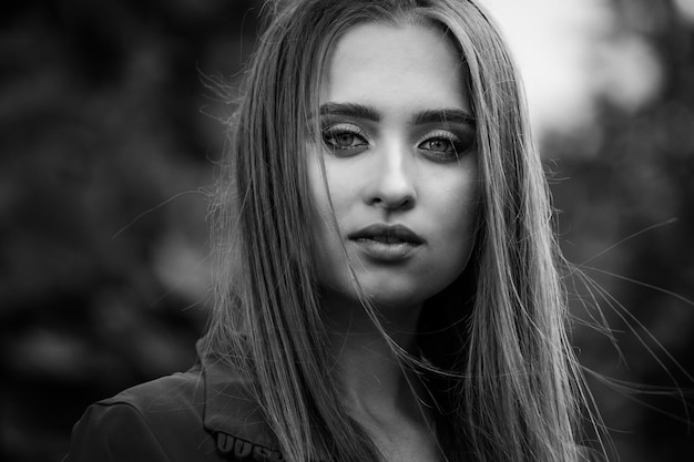 Beauty portrait of a young beautiful girl with long straight flying hair