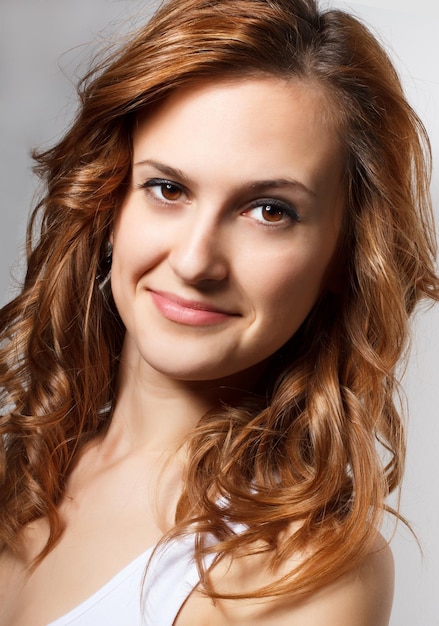 Beauty portrait of a young brunette woman with beautiful smile