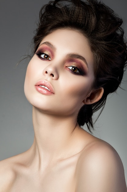 Beauty portrait of young woman with modern smokey eyes makeup