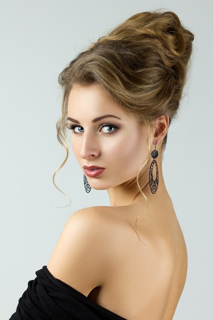 Beauty portrait of young woman with stylish hairdo