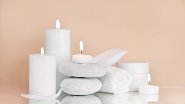 Beauty products with Towel, candles and white stone