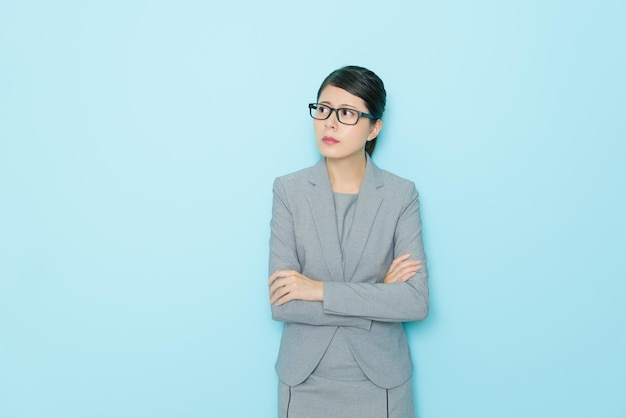 beauty professional manager woman getting angry standing in blue background office relaxing and thinking company problem solution.