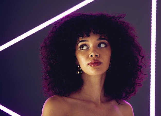 Beauty purple light and a woman in studio with neon uv for makeup skin cosmetic and self love Face of aesthetic gen z black person model on a background for natural afro or art glow and fashion