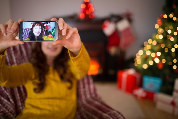 Beauty redhead taking a selfie at christmas