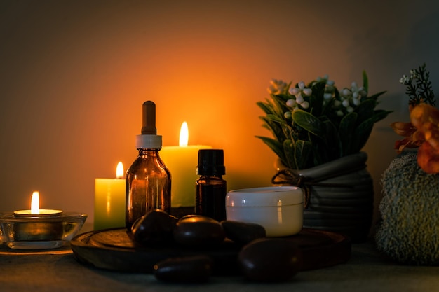 Beauty and relaxation treatment in a spa. Essential oils, massage stones, creams on a light table in an environment of visual relaxation. CopySpace.