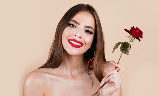 Beauty romantic smiling woman with red rose flowers beautiful luxury makeup valentines day design po