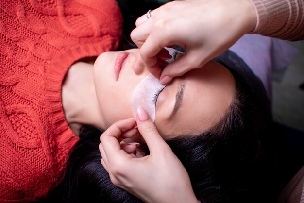 Beauty salon, eyelash extension procedure close up