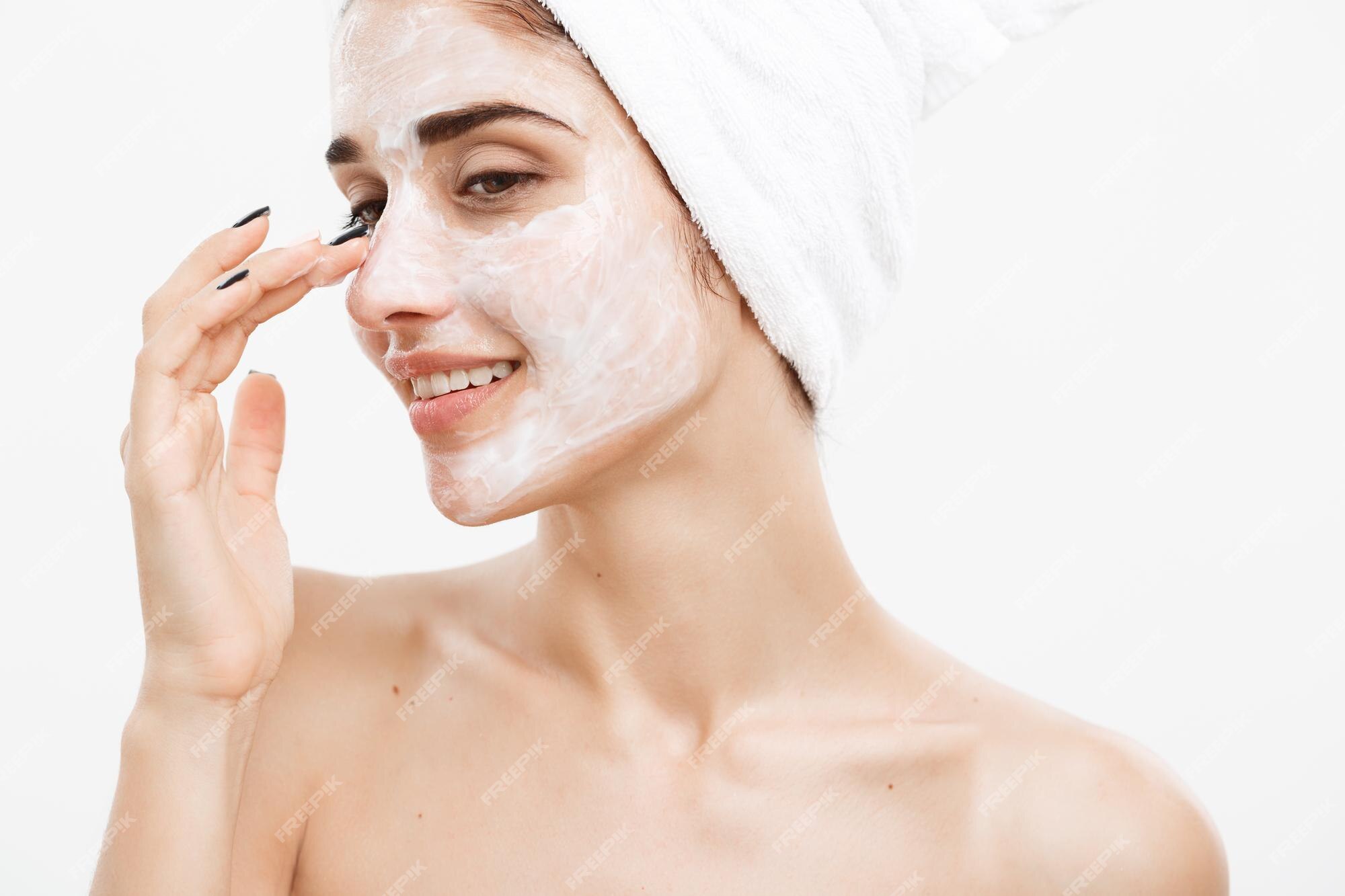 Premium Photo | Beauty skin care concept beautiful caucasian woman face  portrait applying cream mask on her facial skin white background