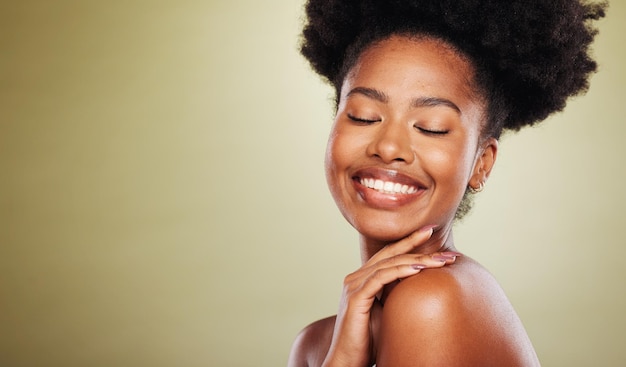 Beauty skincare and black woman in a studio for a natural face routine with mockup space Happy smile and African model with a smile doing a facial treatment by a green background with copy space