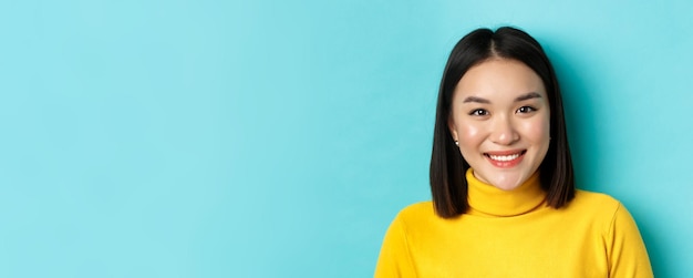 Beauty and skincare concept close up of smiling asian female model with perfect skin and white teeth