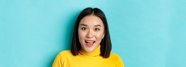 Beauty and skincare concept close up of surprised asian female raising eyebrows and look amused at person