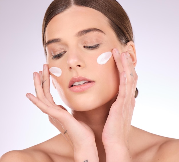 Beauty skincare or girl with face cream product in daily grooming treatment with makeup cosmetics in studio dermatology mockup space background or female model applying facial sunscreen lotion