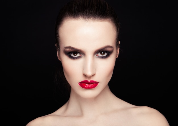 Beauty smokey eyes red lips makeup fashion model on black background