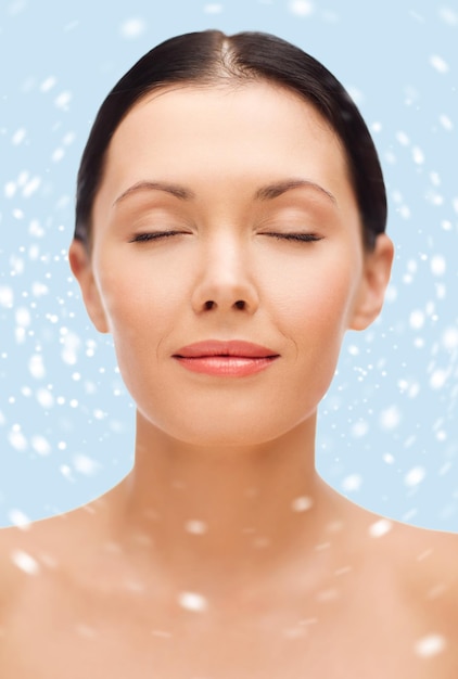 beauty, spa and health concept - relaxed young woman with closed eyes