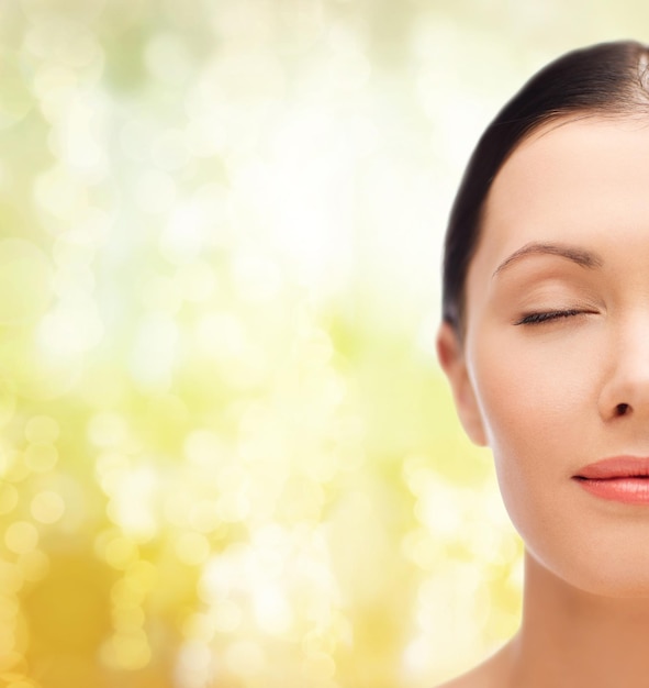 beauty, spa and health concept - relaxed young woman with closed eyes