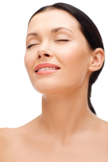 beauty, spa and health concept - smiling young woman with closed eyes