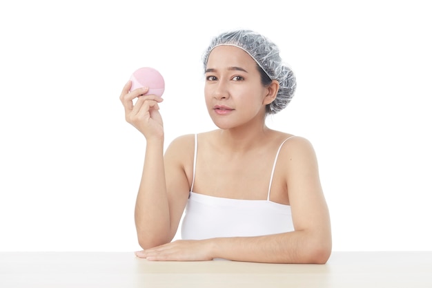 Photo beauty spa woman with perfect skin portrait. beautiful brunette attractive mixed race asian female model wearing bath towel and shower cap perfect skin on white