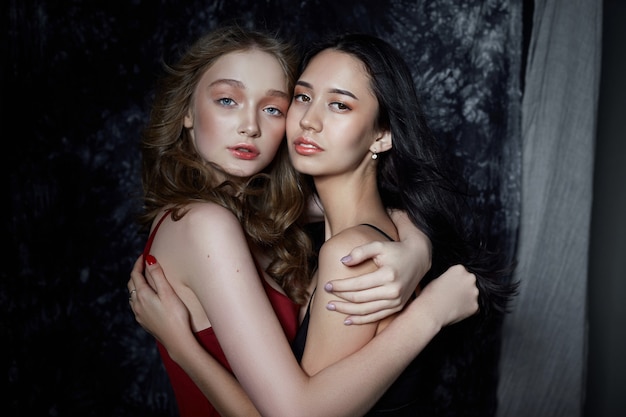 Beauty spring portrait of two girls. Women hug and pose