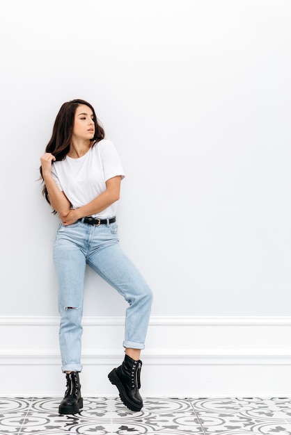 Beauty styled portrait of a young caucasian woman Fashion girl with curly hair posing in the studio on a white background isolated Studio shot