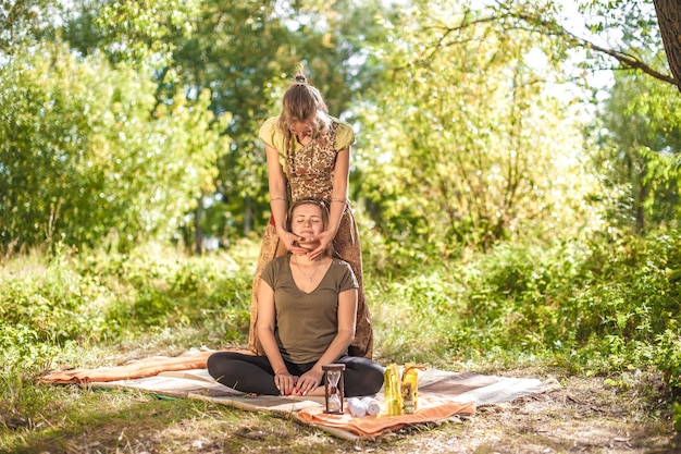 Beauty treatment. Master massage performs a relaxing massage on the ground.