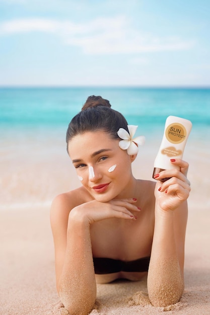 Beauty woman in bikini holding bottles of sunscreen in hands
skin care female applying sun cream