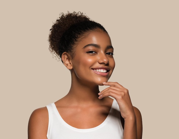 Beauty woman black skin face smiling model touching her face. Color background. Brown