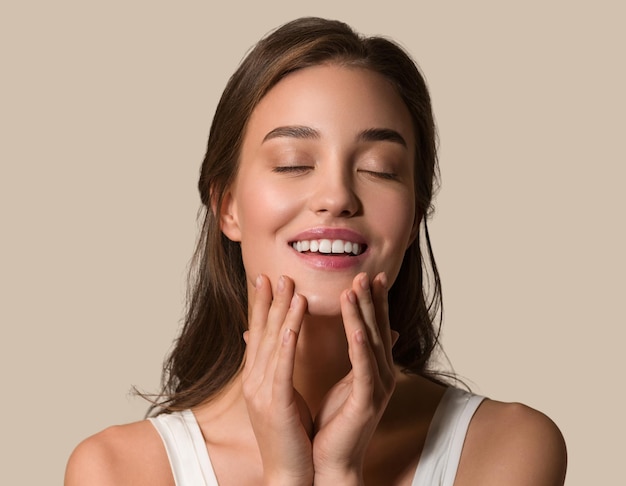 Beauty woman face healthy skin care female beautiful woman Touching her face. Color brown background