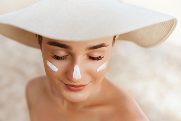 Beauty woman smile applying sun cream on face skin care body\
sun protection sunscreen