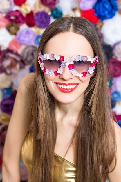 Beauty woman wearing sunglasses with floral petals