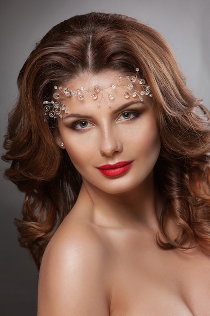 Beauty woman with beautiful makeup. Glamour girl. Brown hair, wavy hair, clear skin, beautiful face.