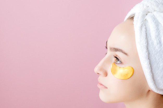 Beauty Woman with Eye Patches on pink background