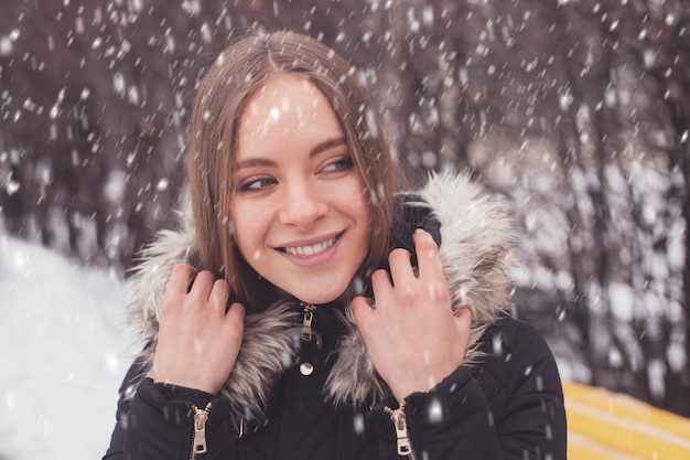 Beauty young woman and show in winter park