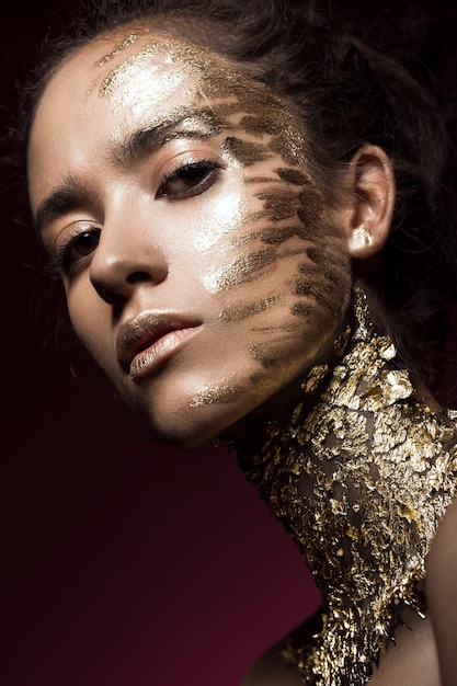 Beautyful girl with gold glitter on her face Art image beauty