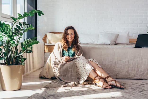 Beautyful woman with charming smile looking at camera at home.