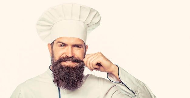Bebaarde chef-kok of bakker Bebaarde mannelijke chef-koks geïsoleerd op wit Baard man en snor met slabbetje schort Luier man Portret van een gelukkige chef-kok Kok hoed